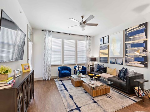a living room with a couch and a ceiling fan