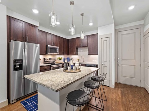 a kitchen with stainless steel appliances and a counter top