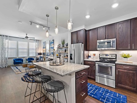 a kitchen with a center island with bar stools
