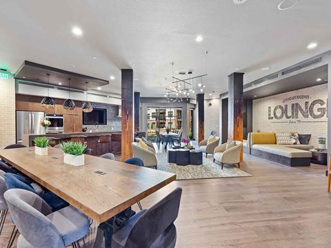 a living room and dining room with a table and chairs