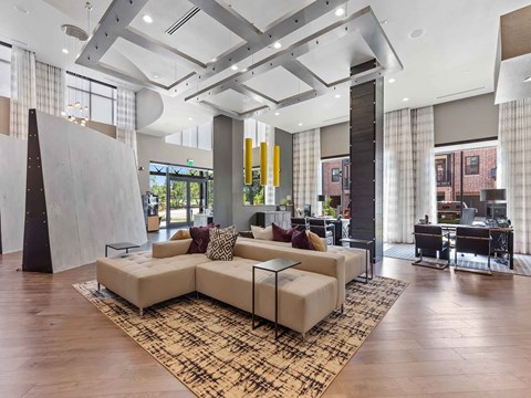 a large living room with a couch and a rug