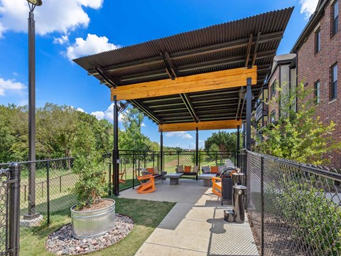 a covered patio with picnic tables and awning on a building