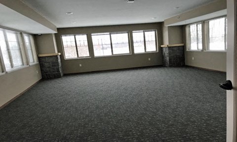 an empty living room with windows in it