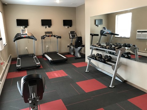 a gym with treadmills and other exercise equipment