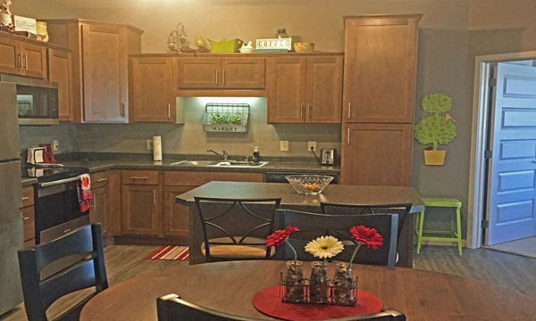 a kitchen and dining room with a table and chairs