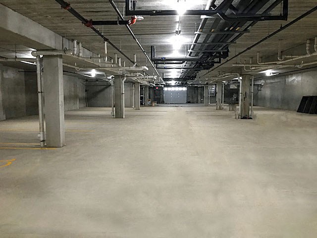 the inside of a building with a large empty parking garage
