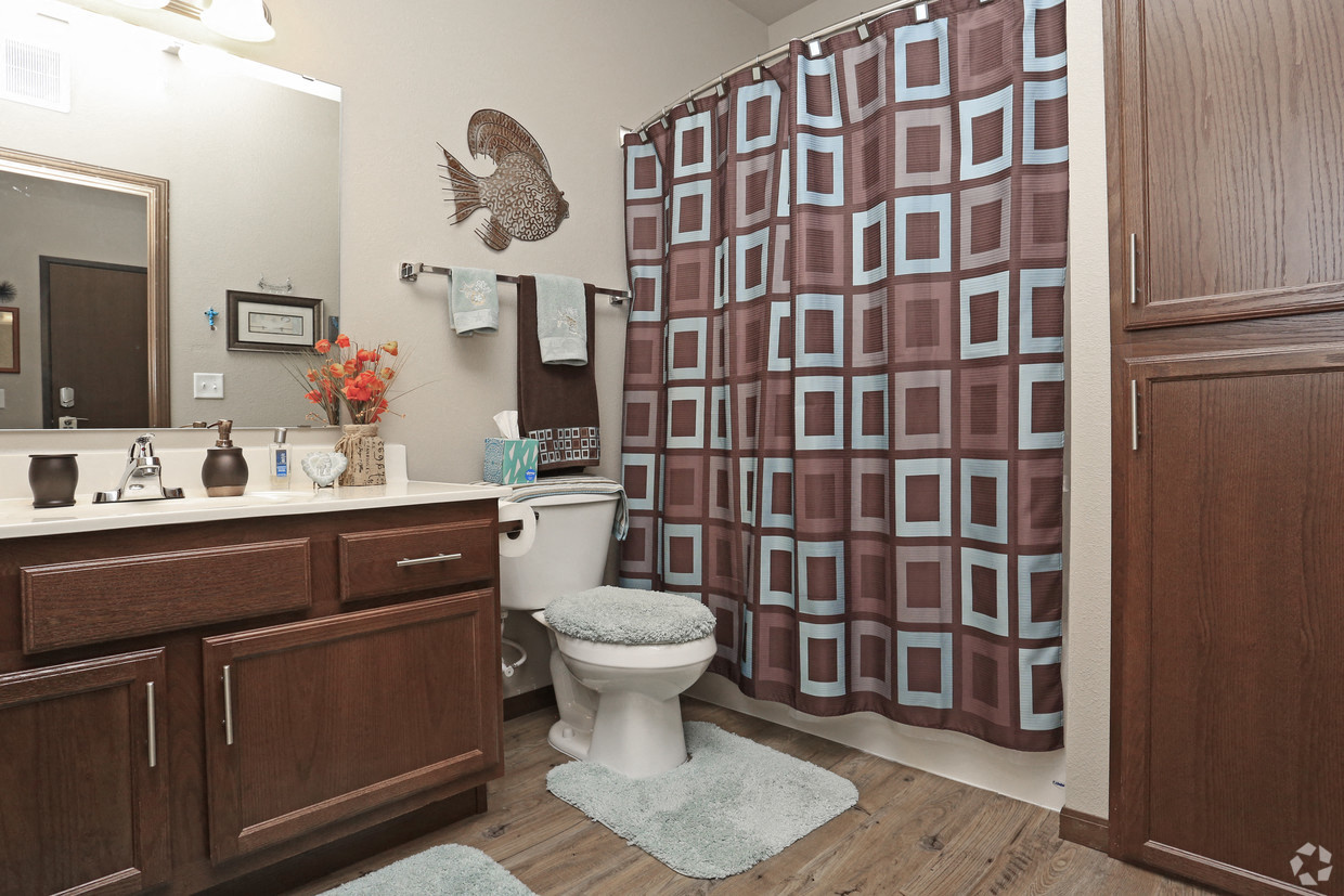 a bathroom with a shower and a toilet and a sink