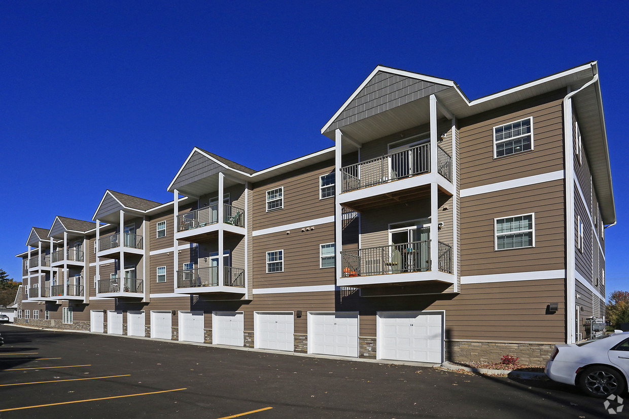 a large apartment building with balconies and a parking lot
