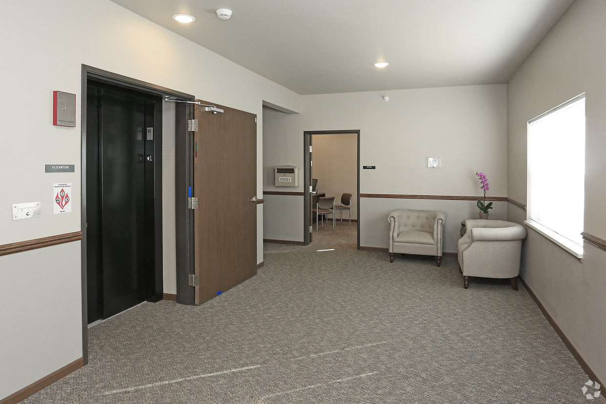 a room with a chair and a couch and a door