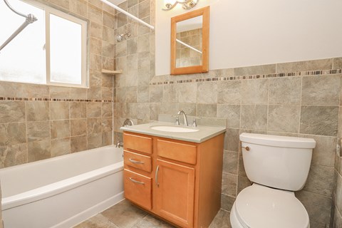 a bathroom with a sink toilet and a bath tub