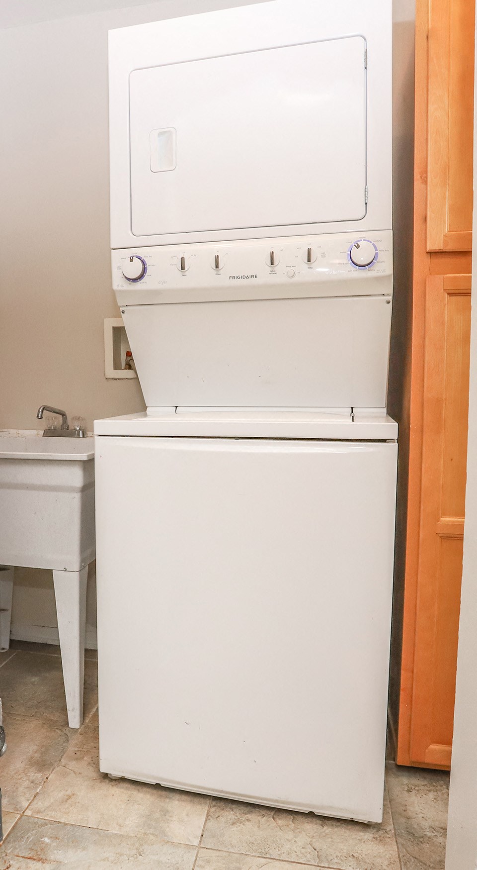 the laundry room has a washer and dryer and a sink