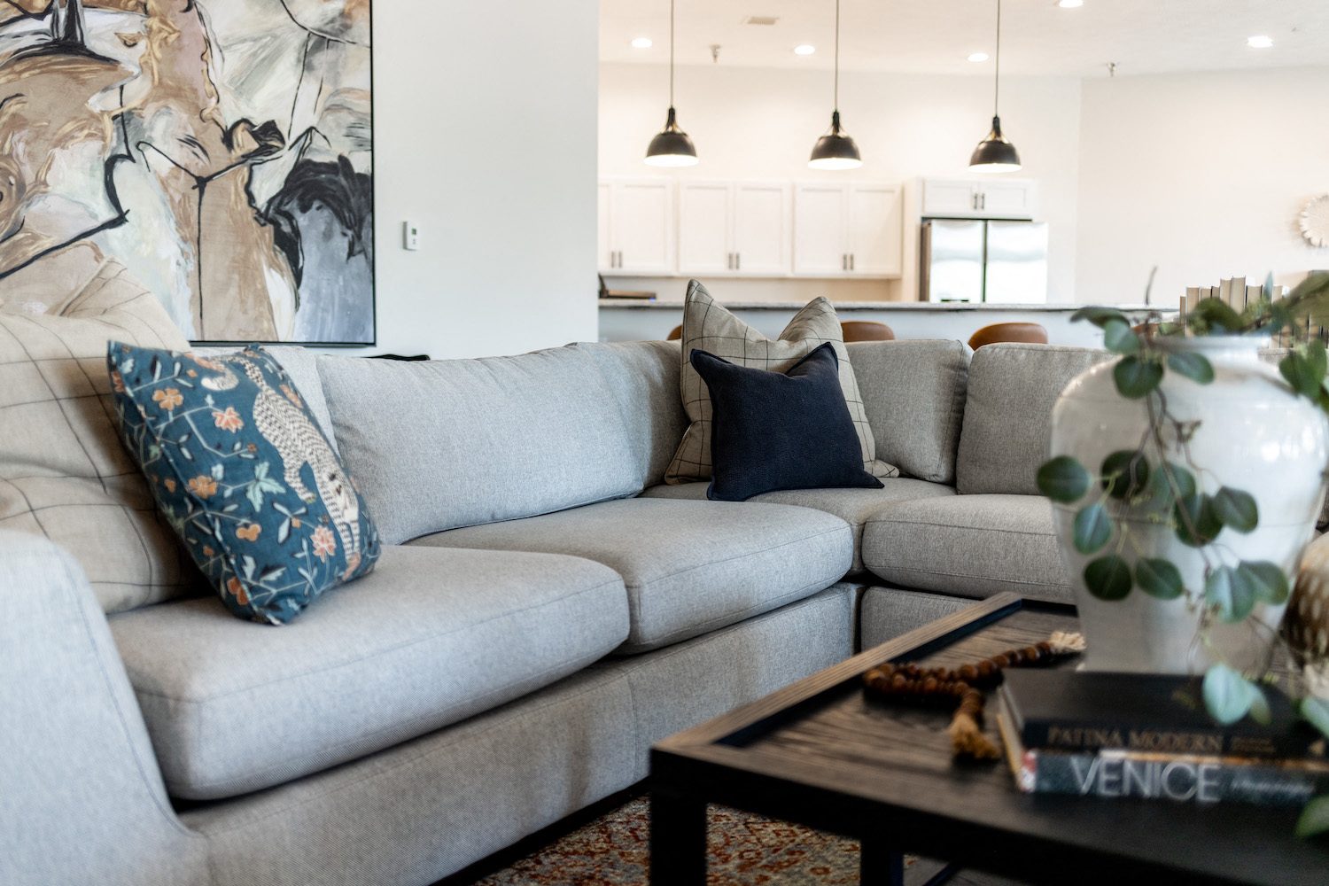 a living room with gray couches and pillows and a coffee table