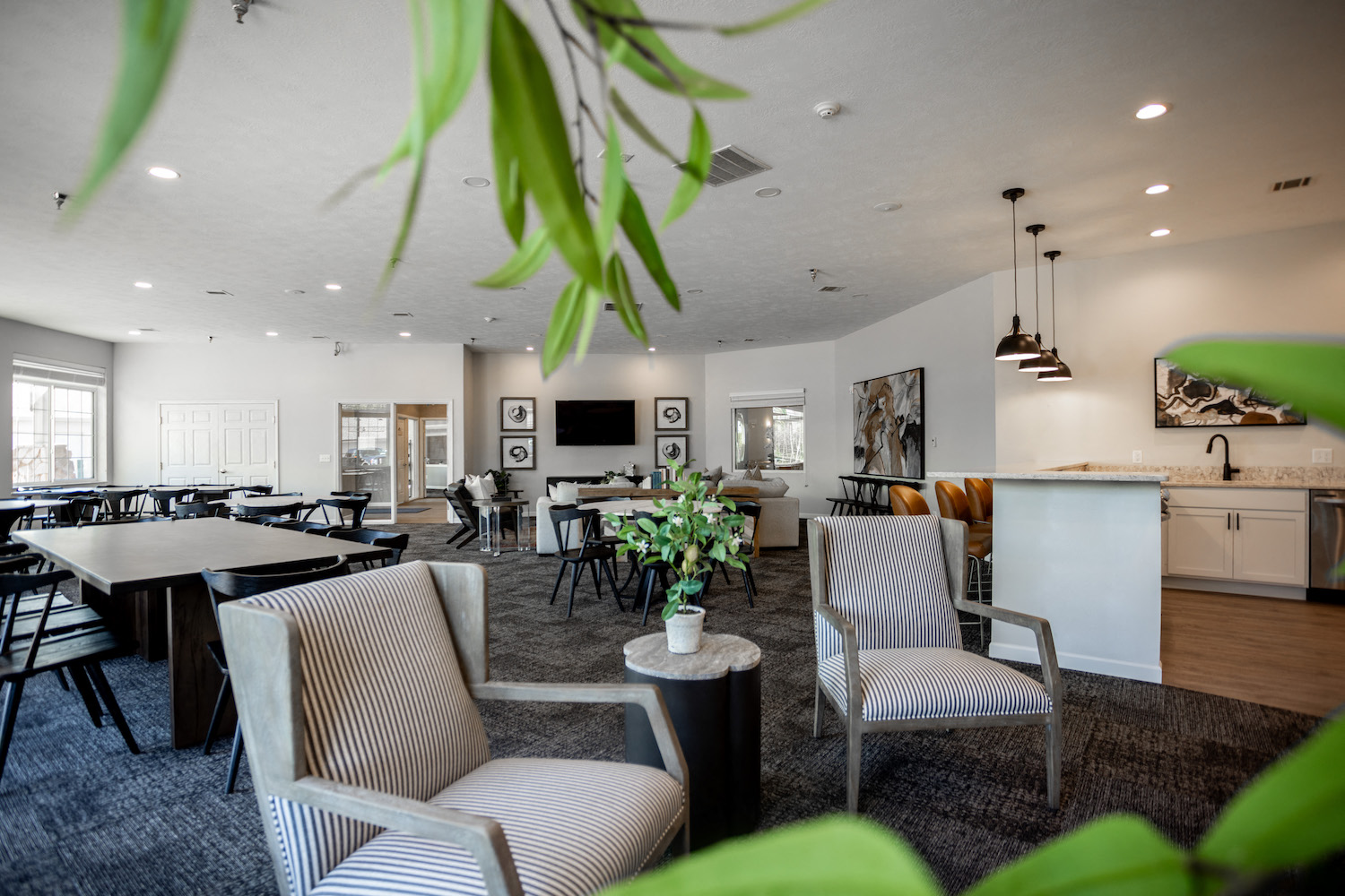 a dining room with chairs and tables and a kitchen