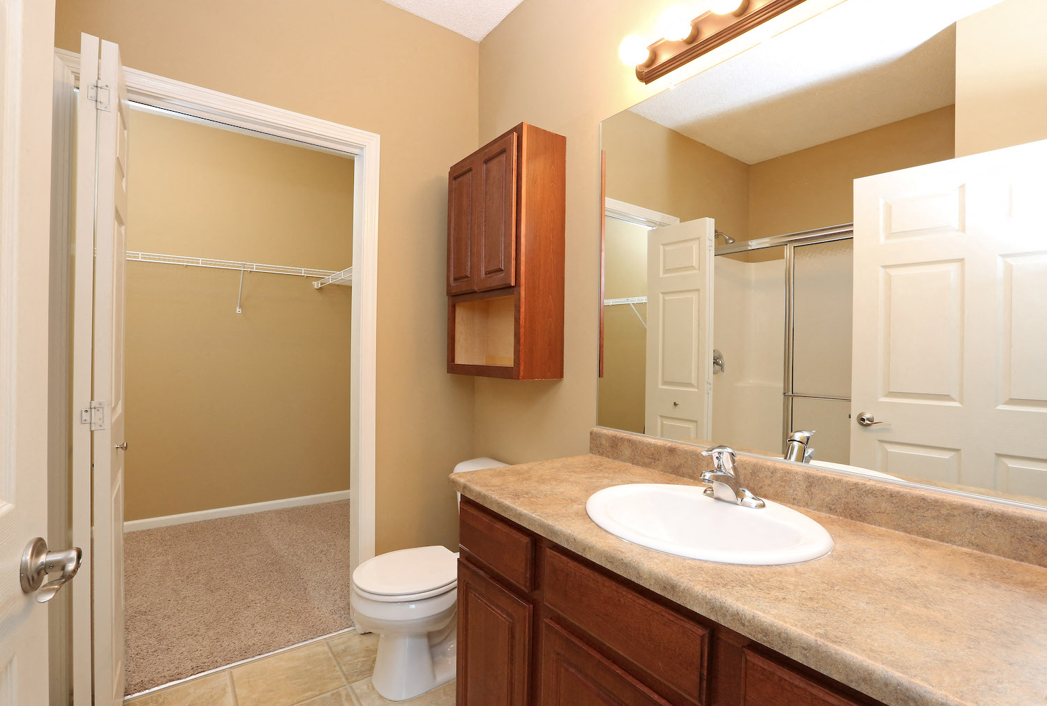 a bathroom with a sink toilet and a mirror