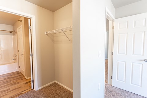 a bedroom with a closet and a door to a bathroom