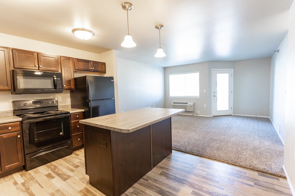 an empty kitchen with a large island in the middle of it