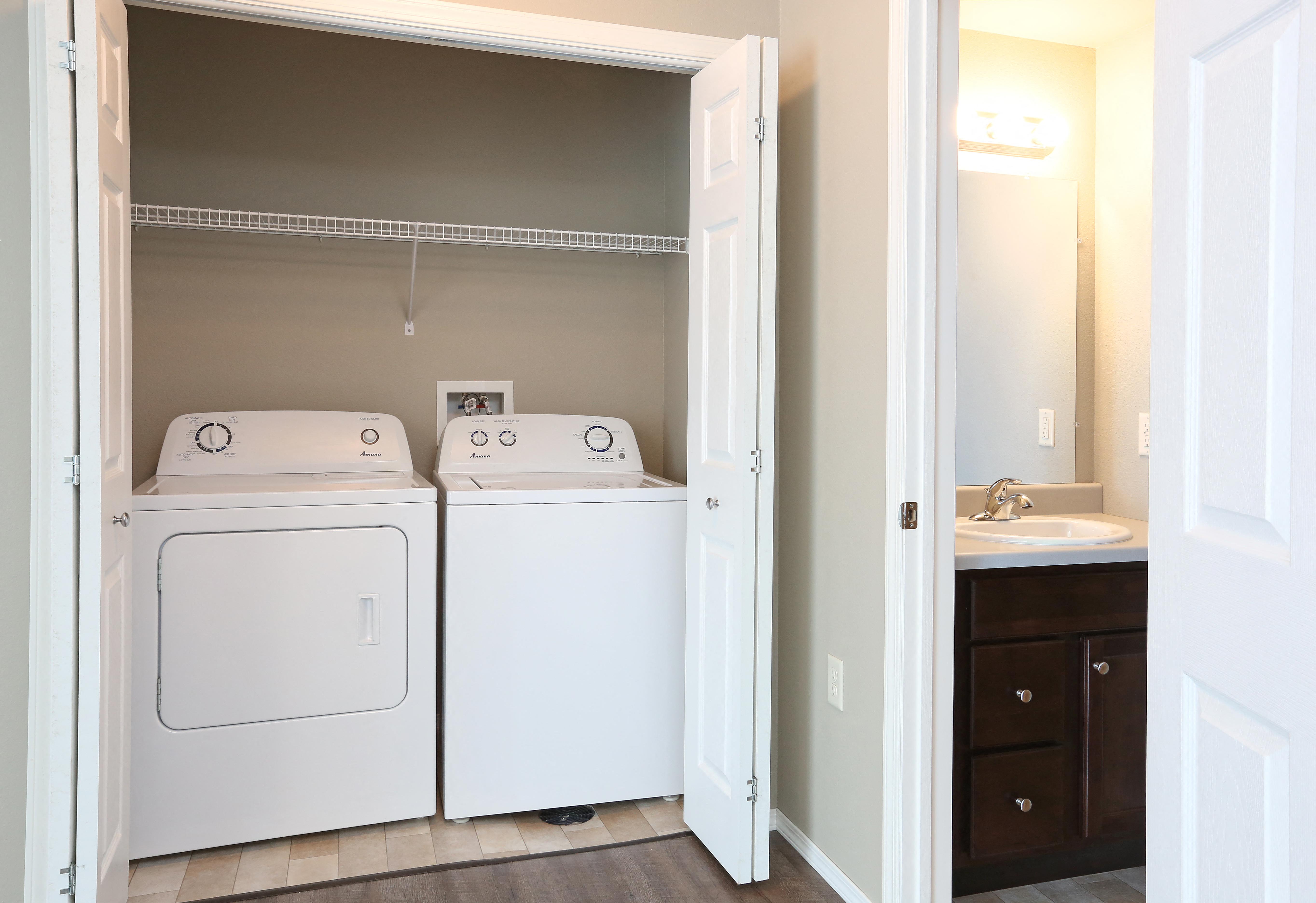 a full view of a washer and dryer in a room with a sink