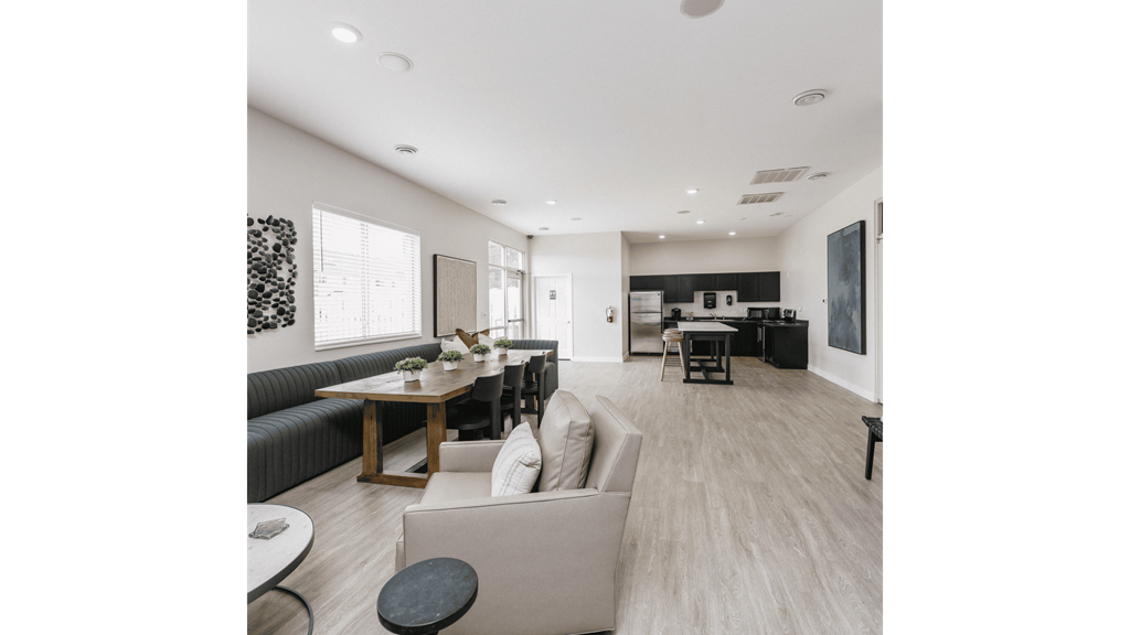 a living room and dining room with couches and a table and chairs