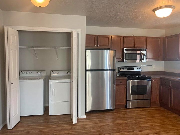 a kitchen with stainless steel appliances and wooden cabinets