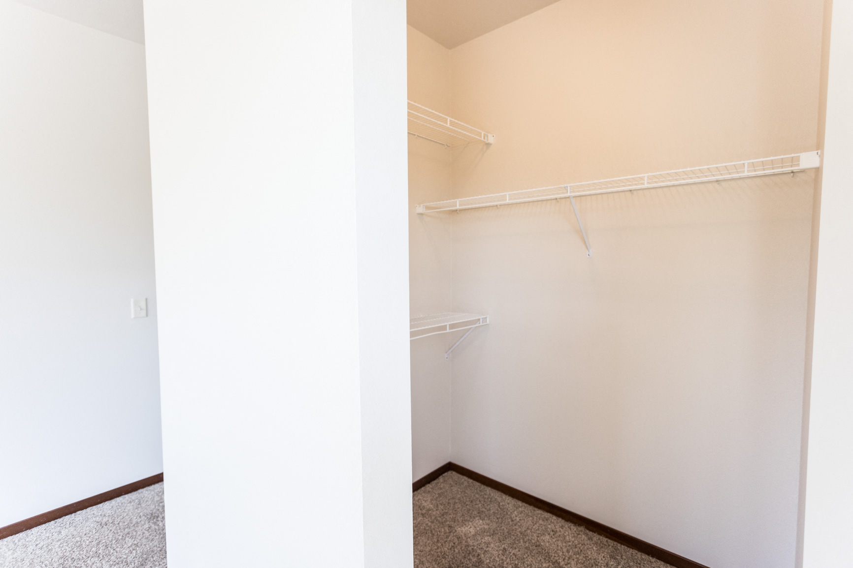 an empty closet in a home with white walls