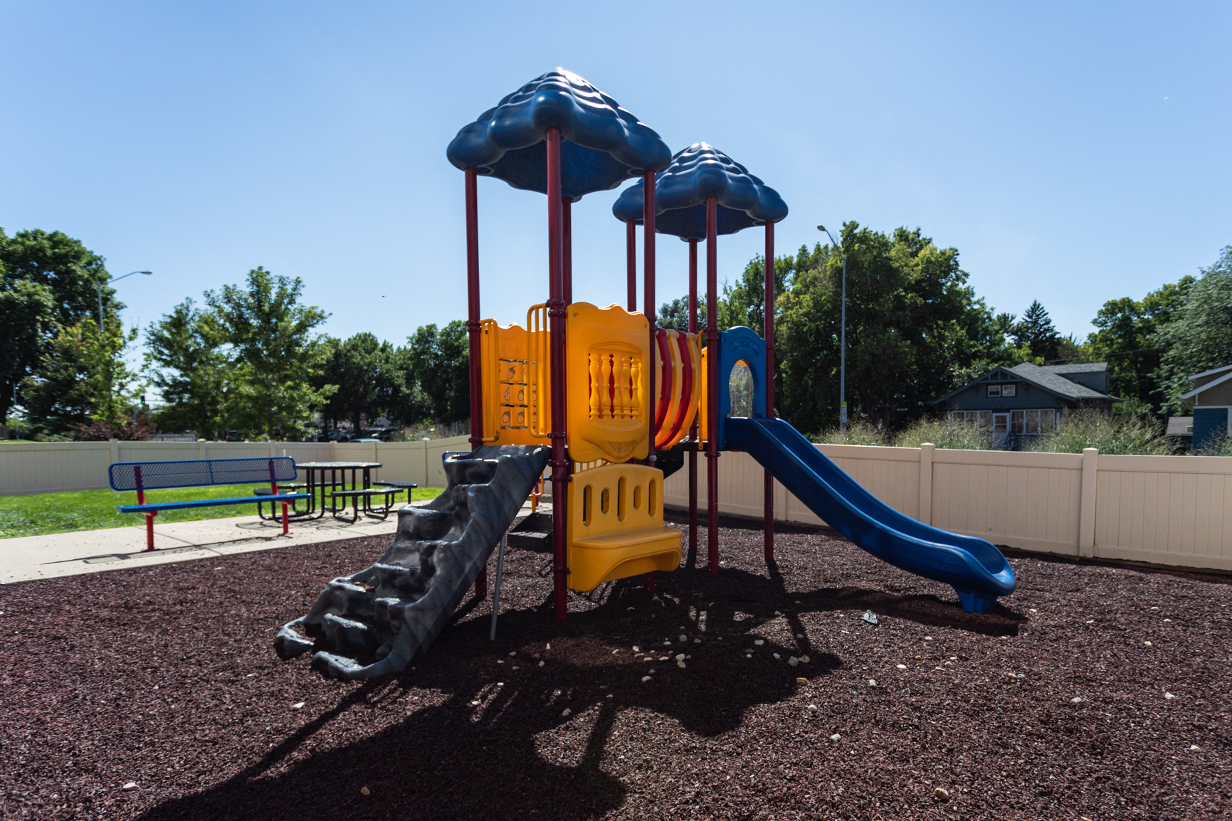 a playground with a swing set and slides