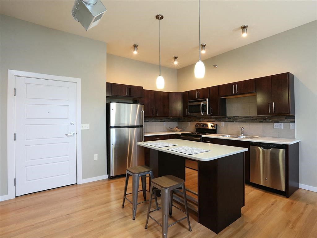 a kitchen with an island and stainless steel appliances
