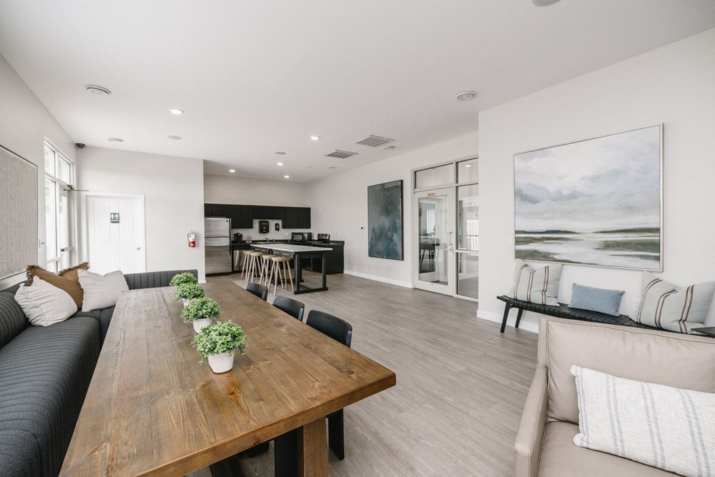 a living room and dining room with a wooden table