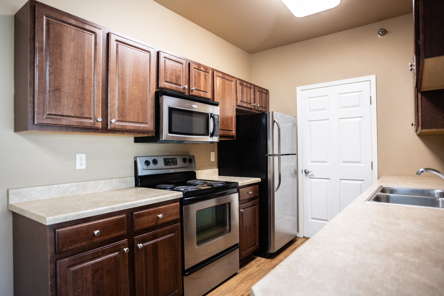 a kitchen with stainless steel appliances and wooden cabinets