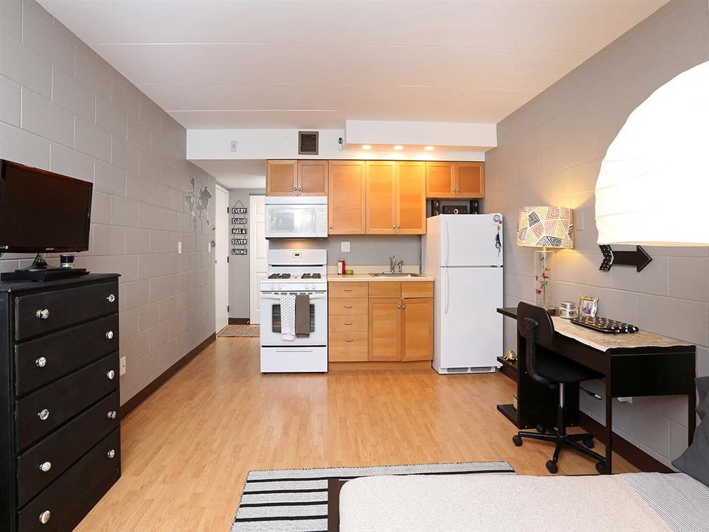 a kitchen with a stove refrigerator and a table