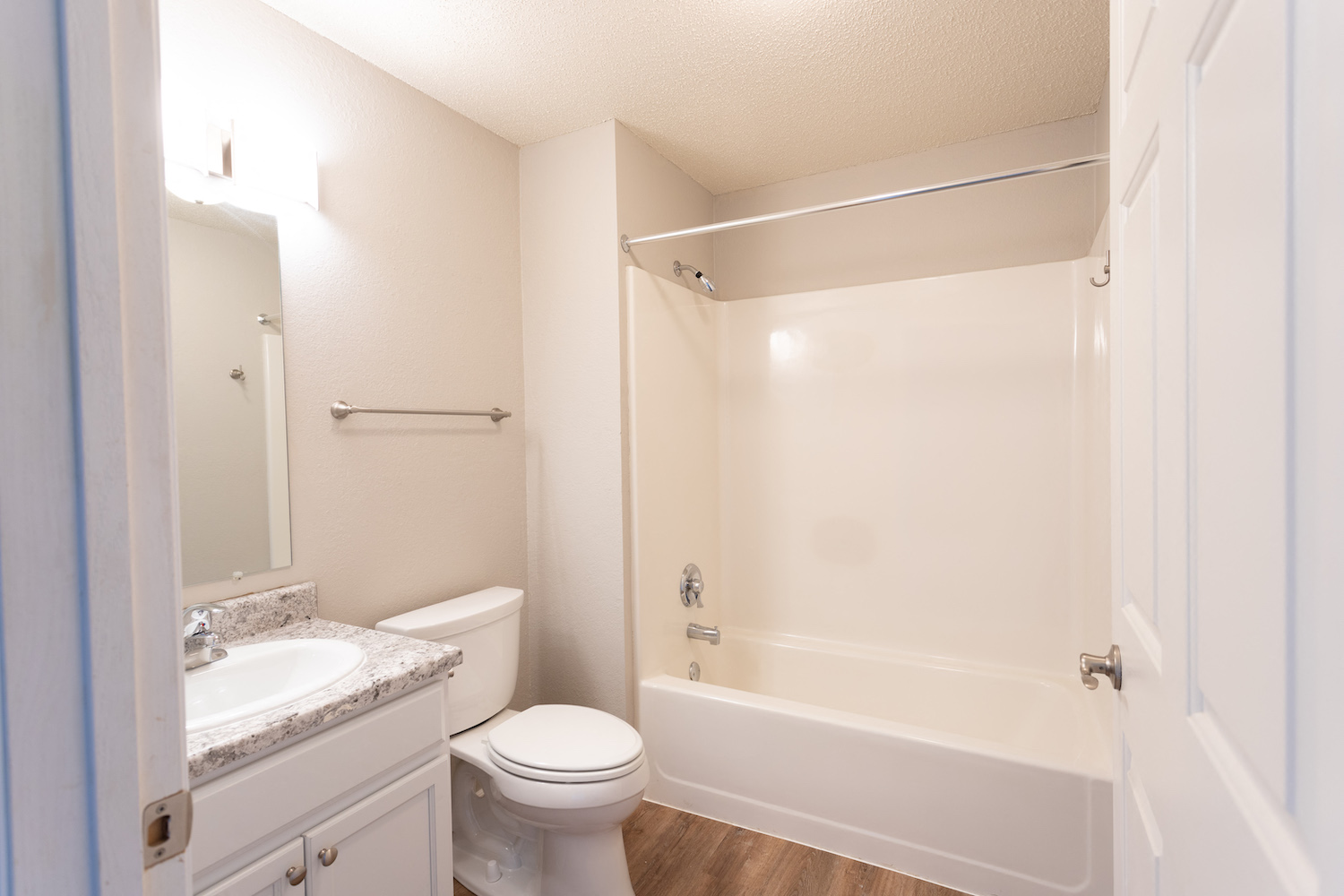 a bathroom with a toilet and a shower and a sink