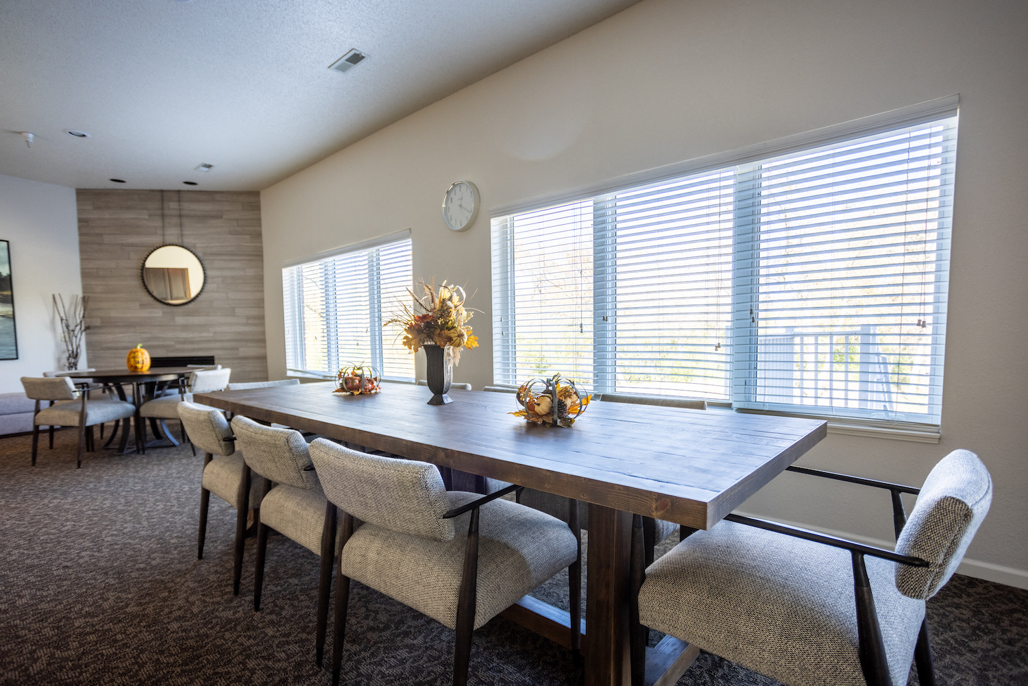 a dining room with a table and chairs and a large window
