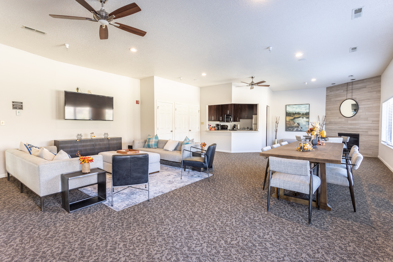 a living room and dining room with couches and a table
