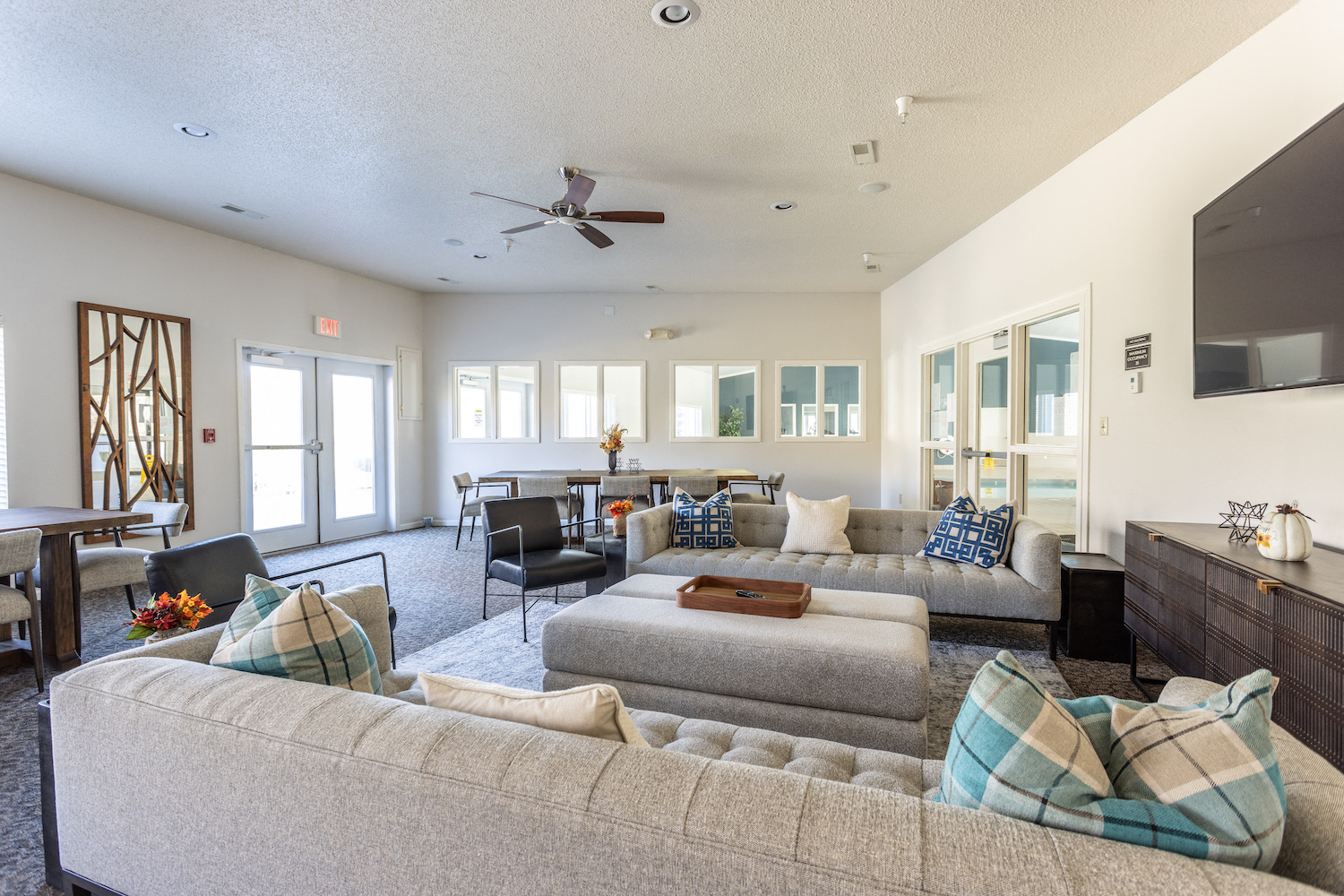 a large living room with couches and chairs and a dining room and a kitchen