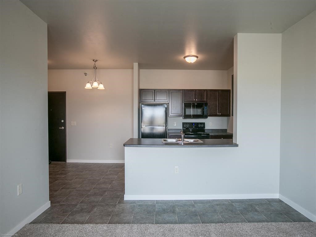 a kitchen with a counter top and a refrigerator
