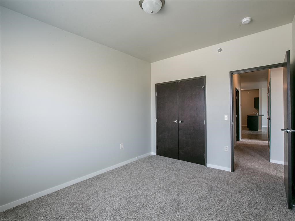 a bedroom with a closet and a door to a hallway