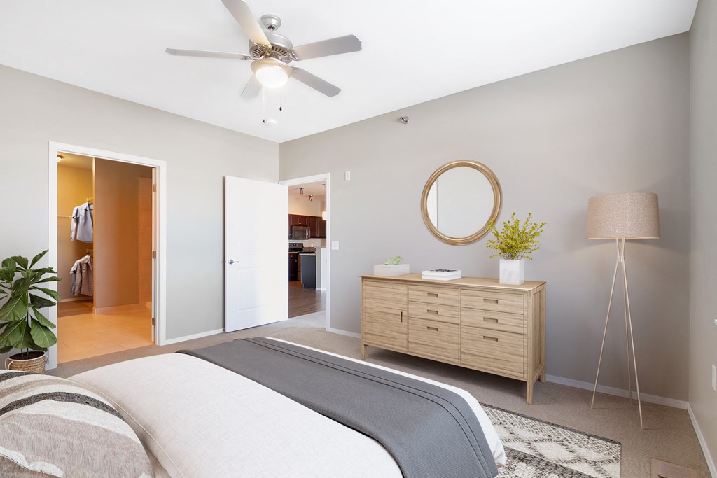 a bedroom with a bed and a ceiling fan