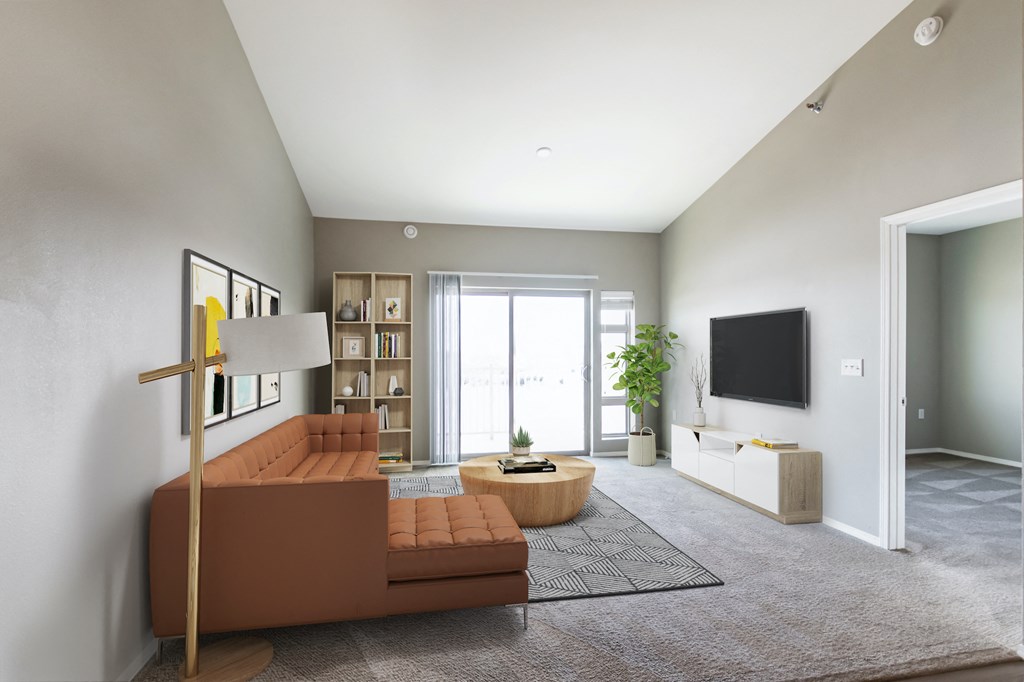 a living room with a brown couch and a tv