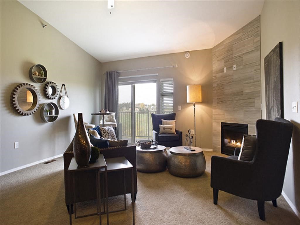 a living room with couches and chairs and a fireplace