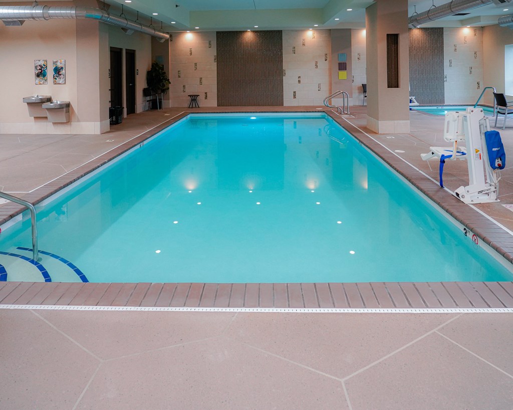 a swimming pool in a hotel with a blue pool water