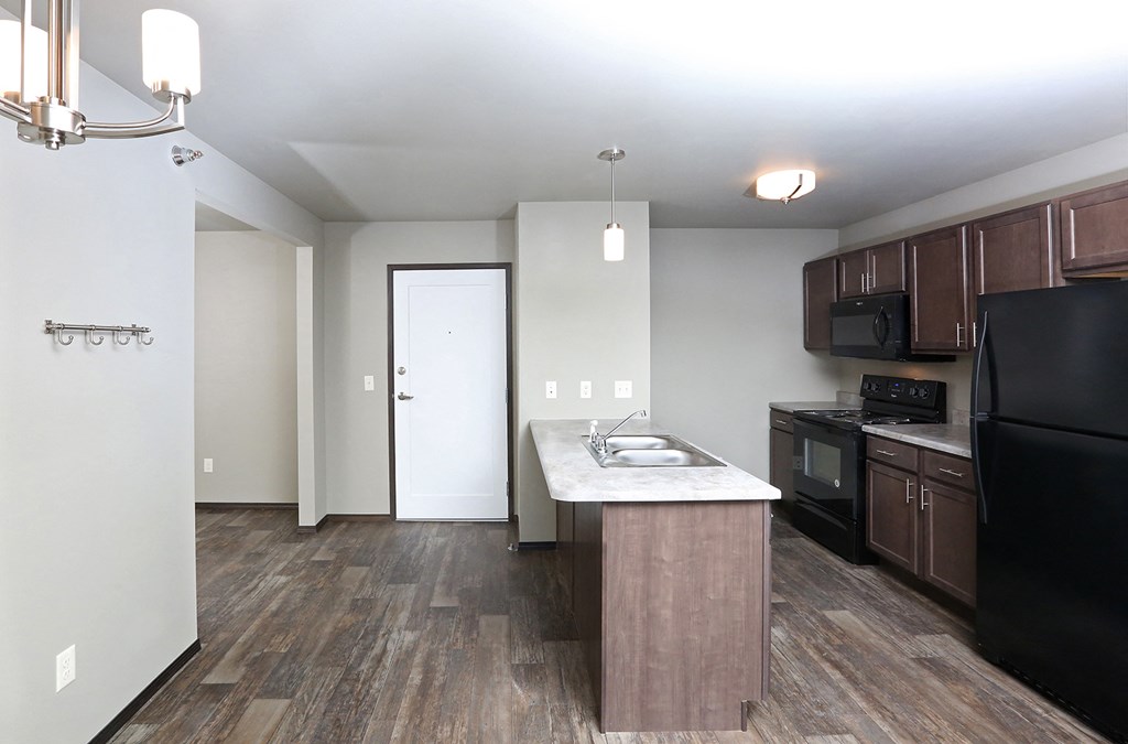 a kitchen with wood flooring and a counter top in a new home
