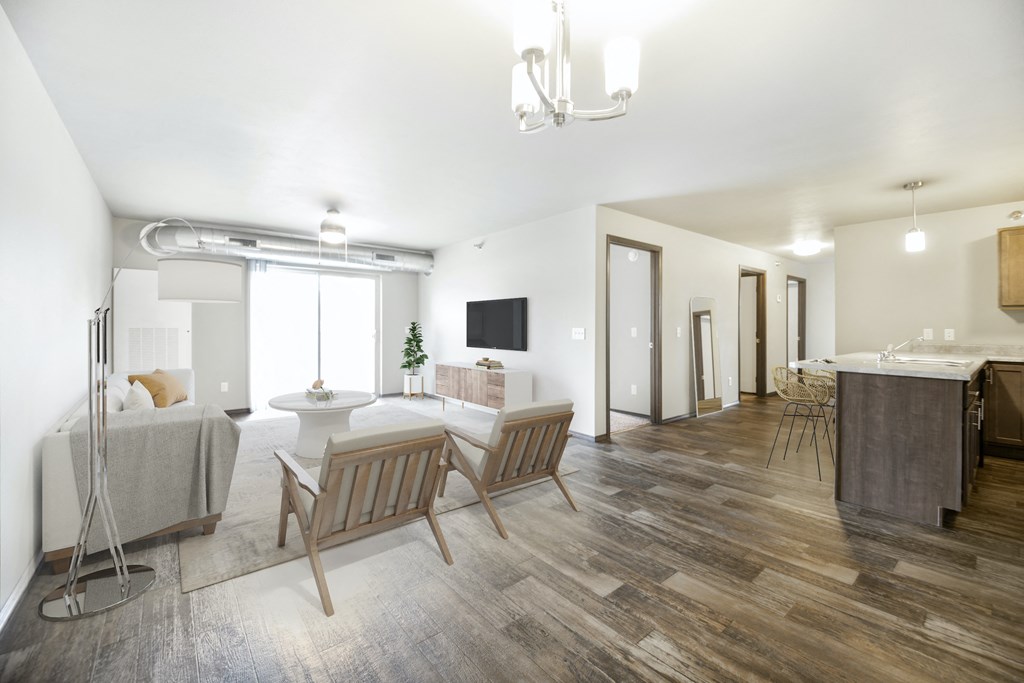a living room and dining room with a table and chairs