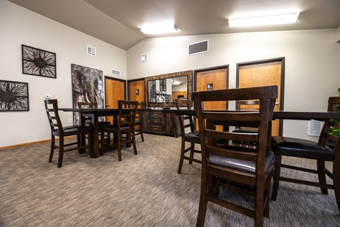 a dining room with a table and chairs and a kitchen