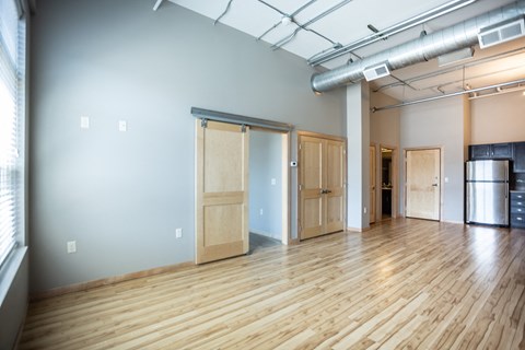 an empty room with wood floors and doors