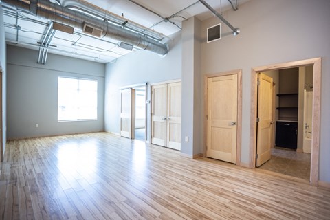 an empty room with wood floors and blue walls