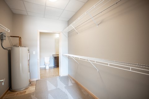 a room with a water heater and a toilet in it