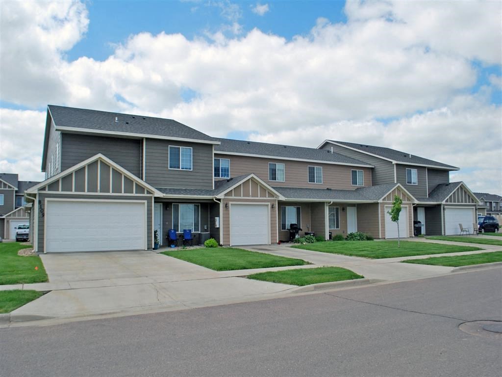 a house with two garage doors on a street