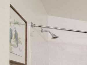 Bathroom with a single sink vanity, grey tile flooring, and a tub shower with subway tile Bathroom with a single sink vanity, grey tile flooring, and a tub shower with subway tile