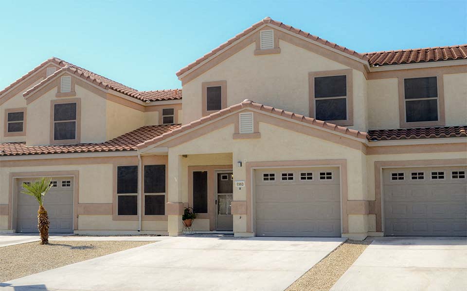 a house with two garage doors and a driveway