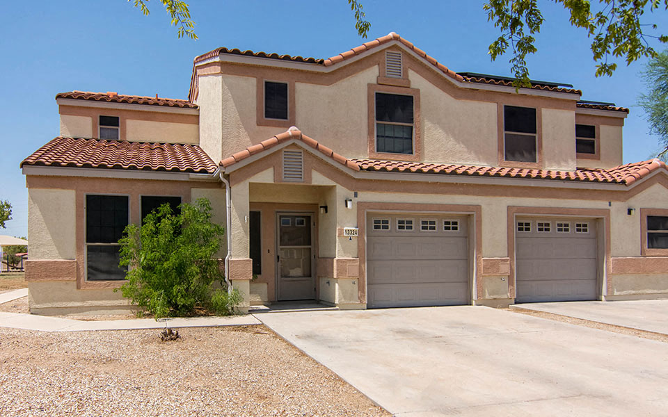 a house with a driveway and two garage doors