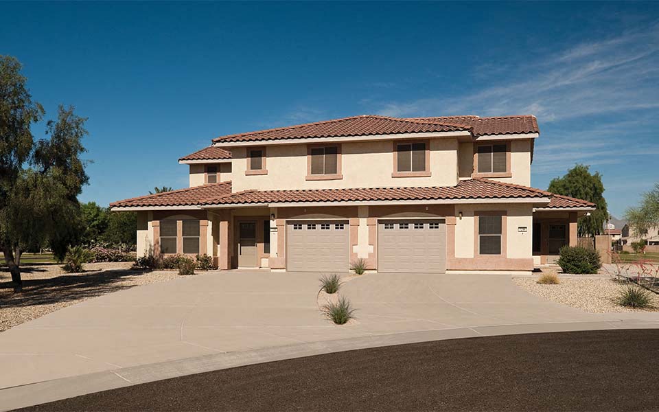a house with two garage doors in a driveway